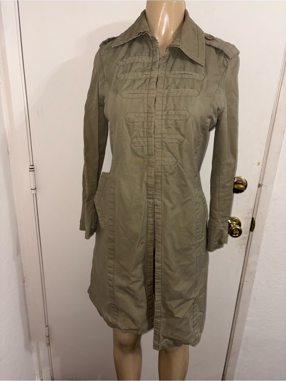 Marc Jacobs green trench coat featuring military-style hook-and-eye closures